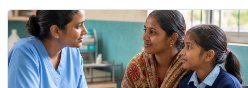 A community health worker providing attentive care.