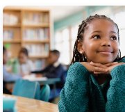 A student looks ahead in her classroom.